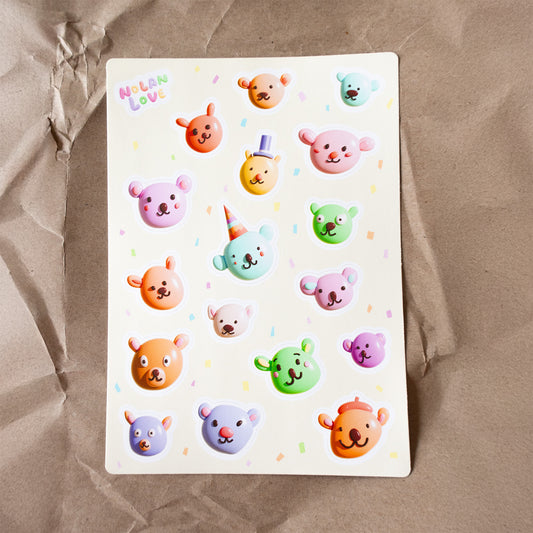 Sheet of colorful bear stickers on a brown paper background