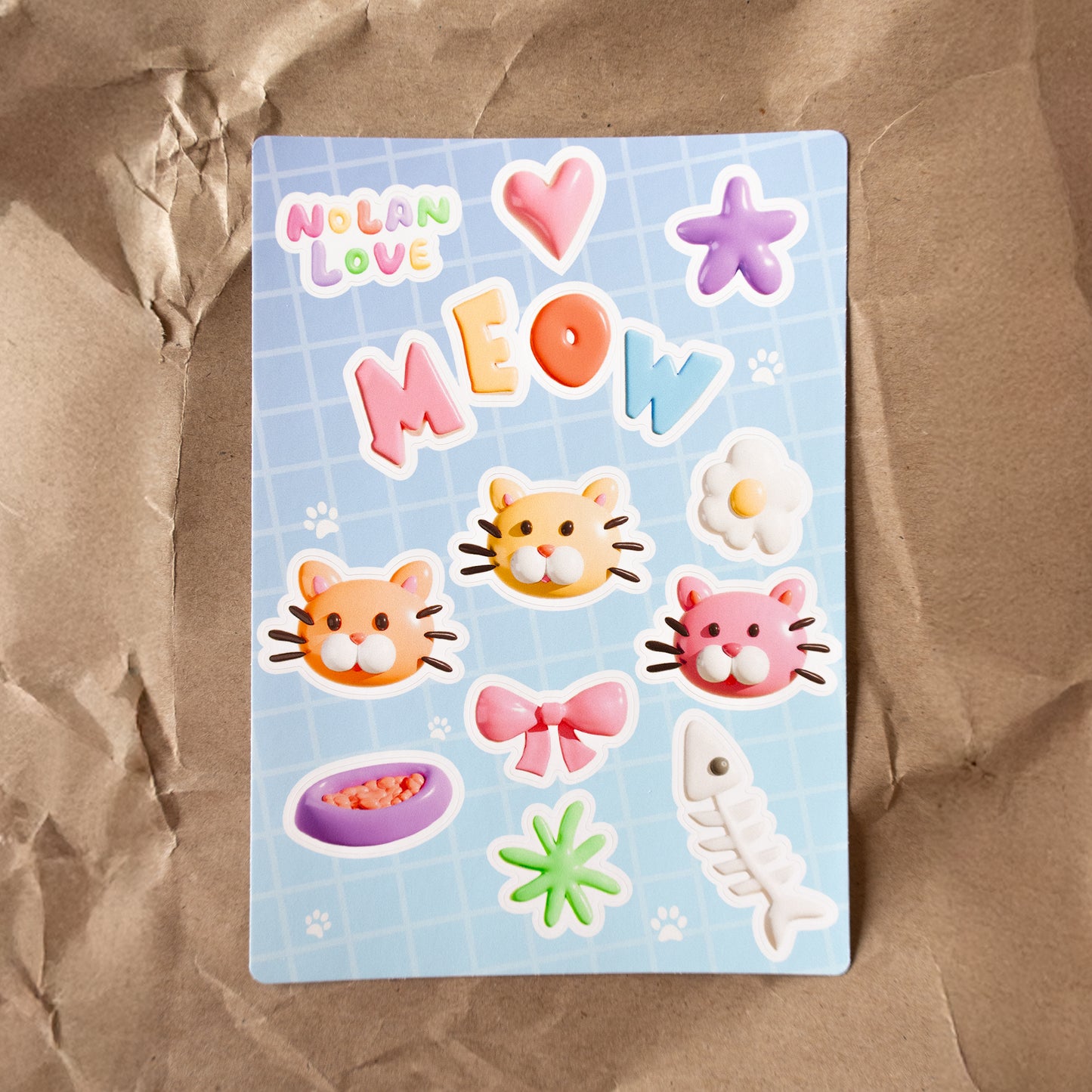 Sticker sheet with cat-themed stickers on a brown surface