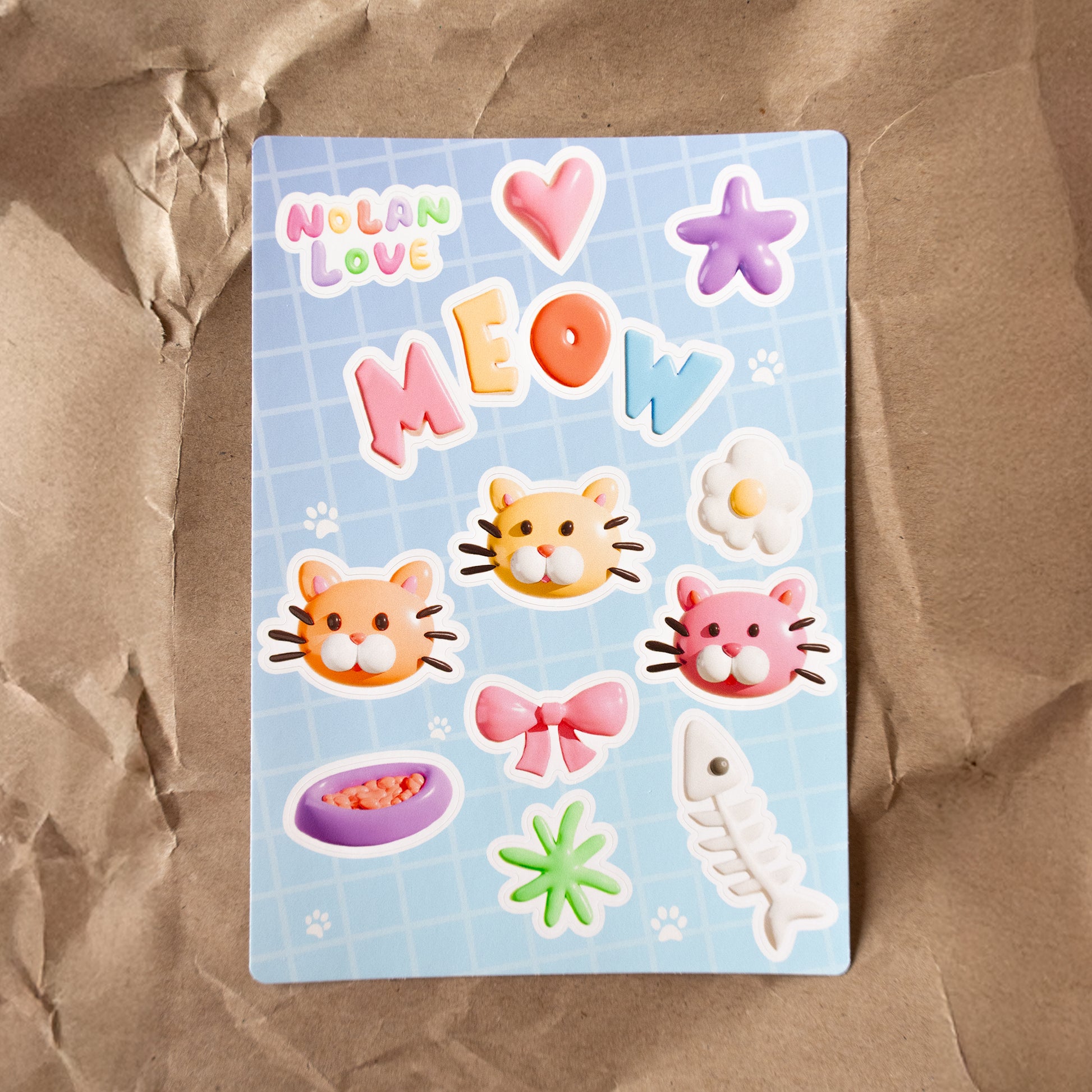 Sticker sheet with cat-themed stickers on a brown surface